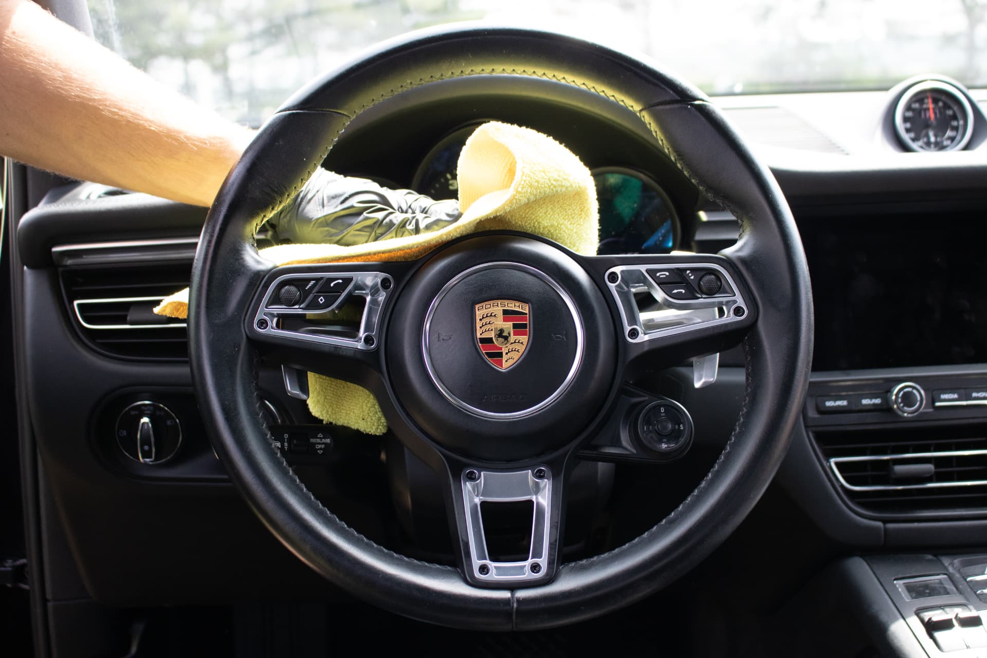 ORO Automotive wiping down a Porsche interior