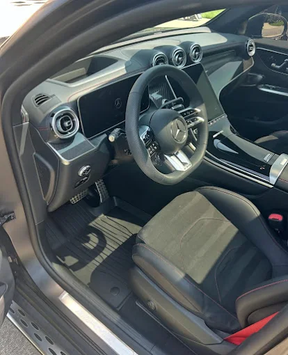 Professional exterior car wash and foam treatment on sedan